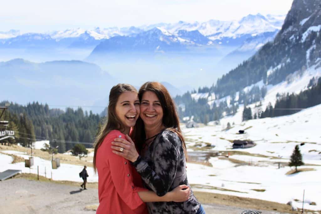 Alexandria and mom hugging in front of the Swiss Alps
