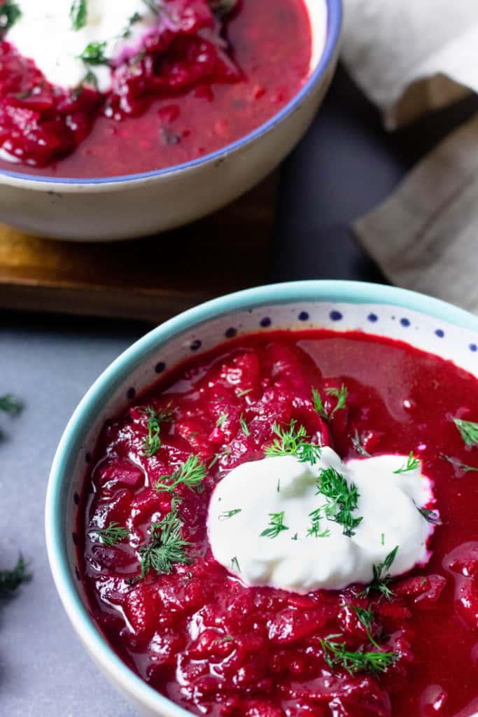 Borscht Soup topped with sour cream close up 