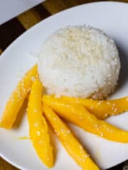 A plate with mango and sticky rice on it.