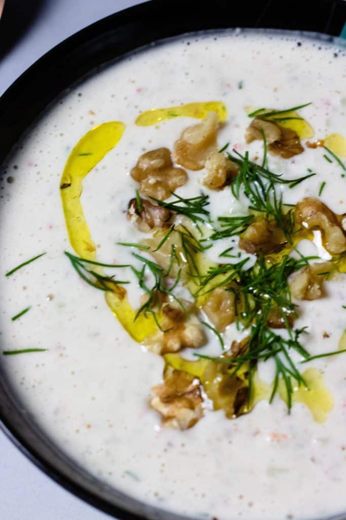 Bowl of soup with olive oil and walnuts
