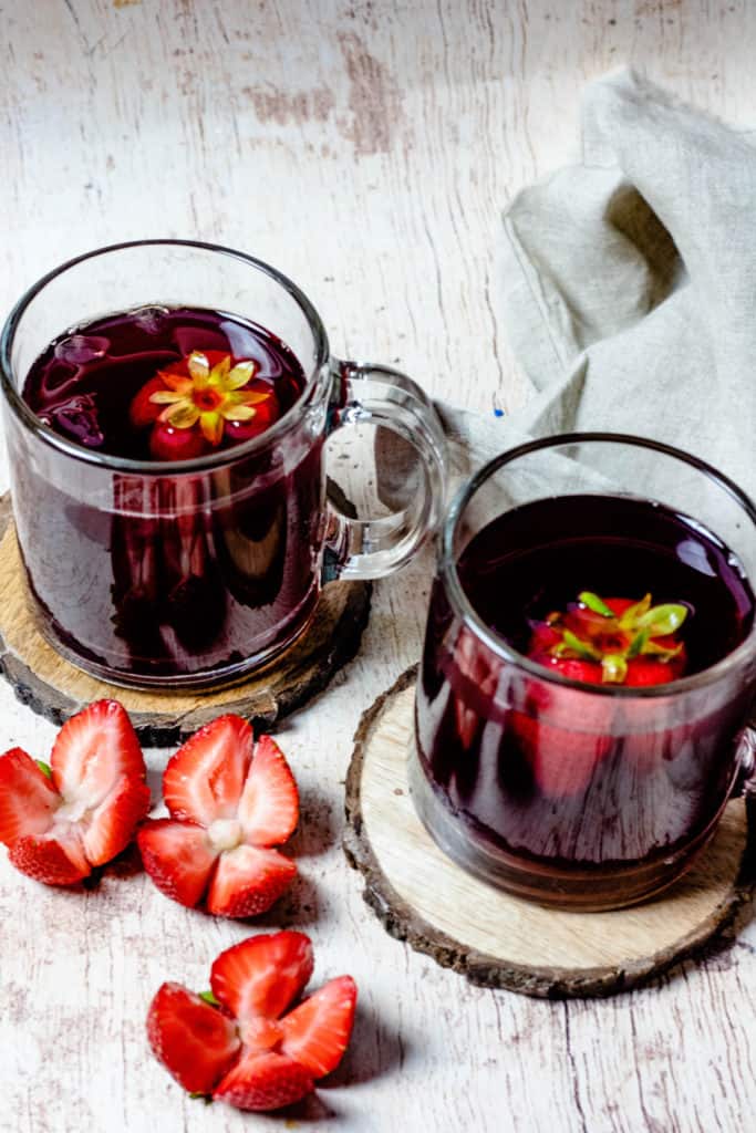 two glasses of hibiscus tea with strawberries
