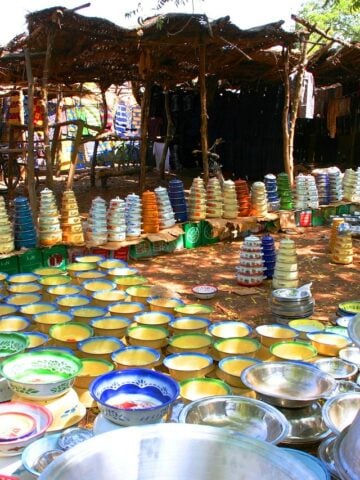 A market in Burkina Faso with gold bowls on the ground.
