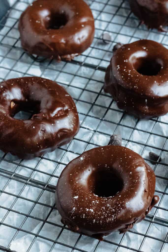 four chocolate covered donuts