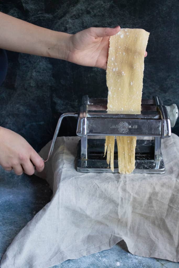 how to make homemade pasta step 8: Roll the pasta through the pasta maker to cut into fettuccine noodles