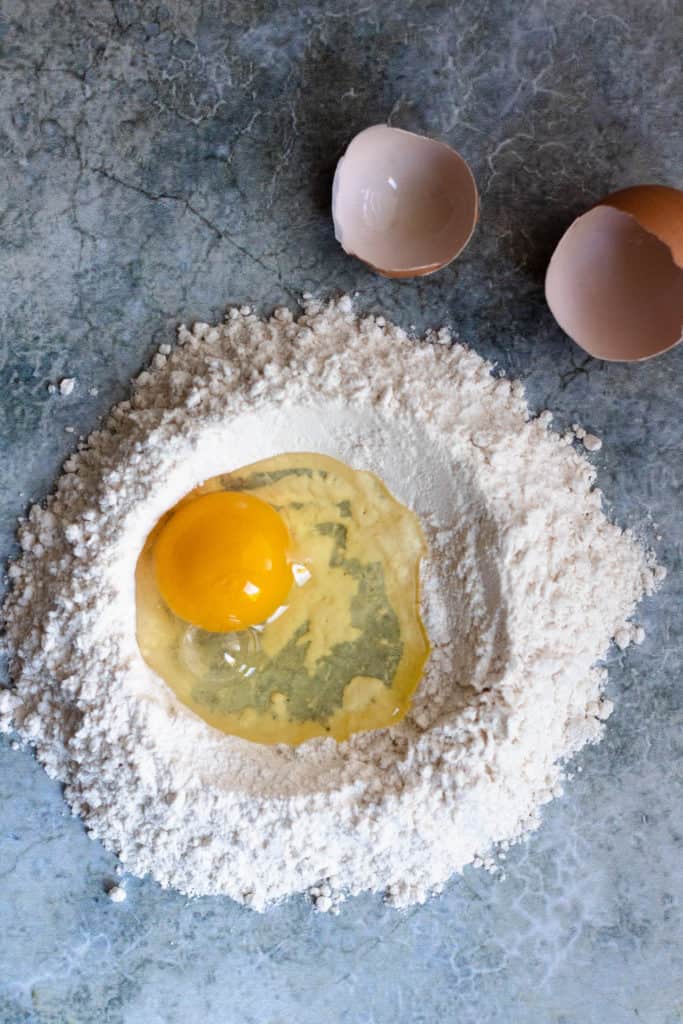 how to make homemade pasta step 2: crack the egg into the well