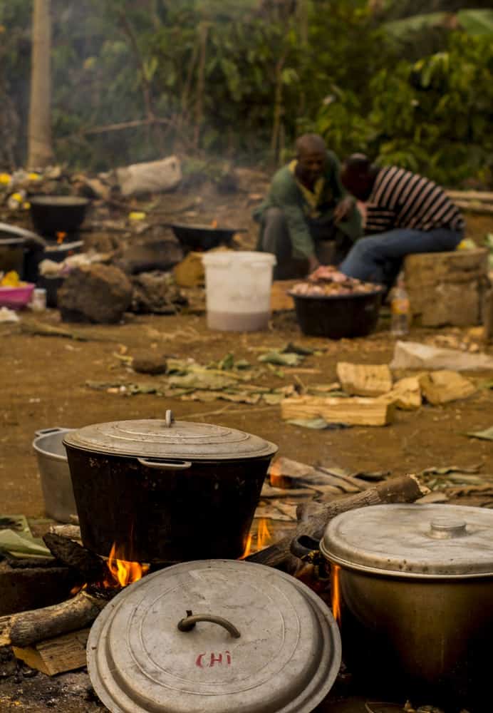 Food cooked in iron pot over wood fire