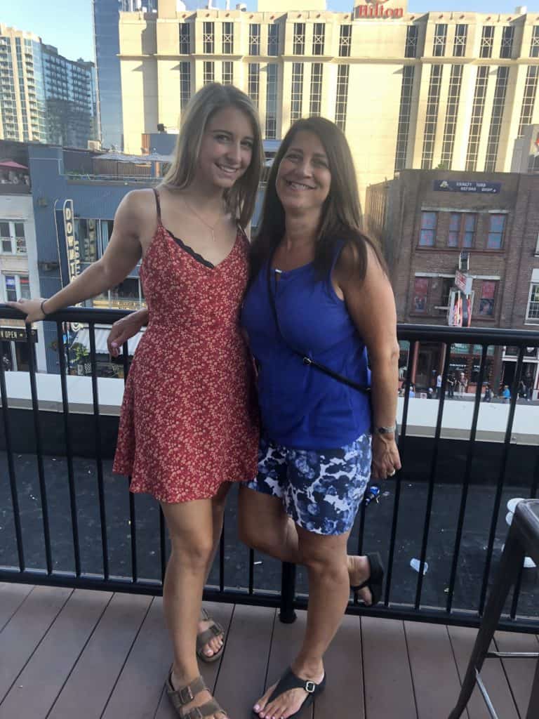 Mother and daughter posing on a balcony in Nashville, TN. 
