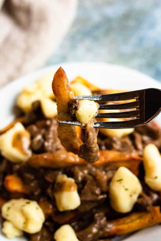 close up of poutine on a fork