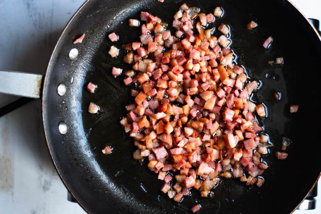 Pancetta cooking in a large pan