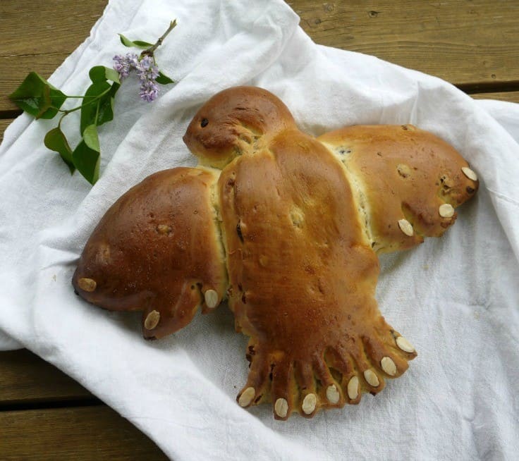 Bread in the shape of a dove on a white sheet