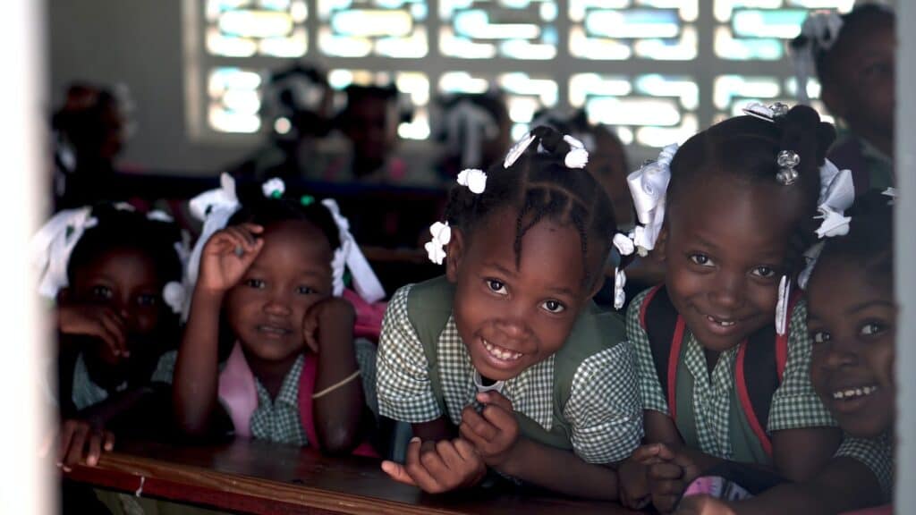 Children in Haiti smiling at the camera. 