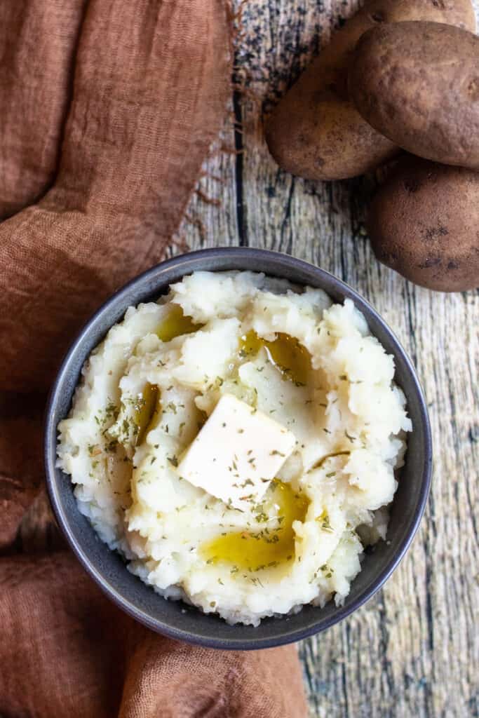 Bowl of mashed potatoes with butter 