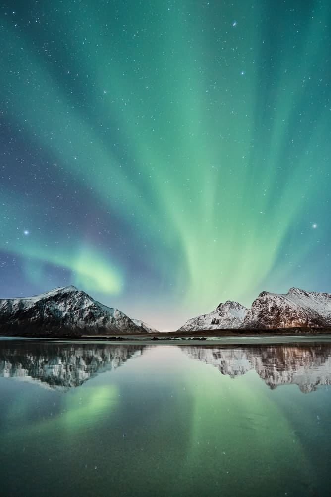 Northern lights over mountains in Norway