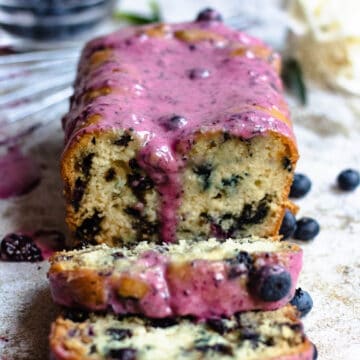 Blueberry bread loaf from the front with purple glaze