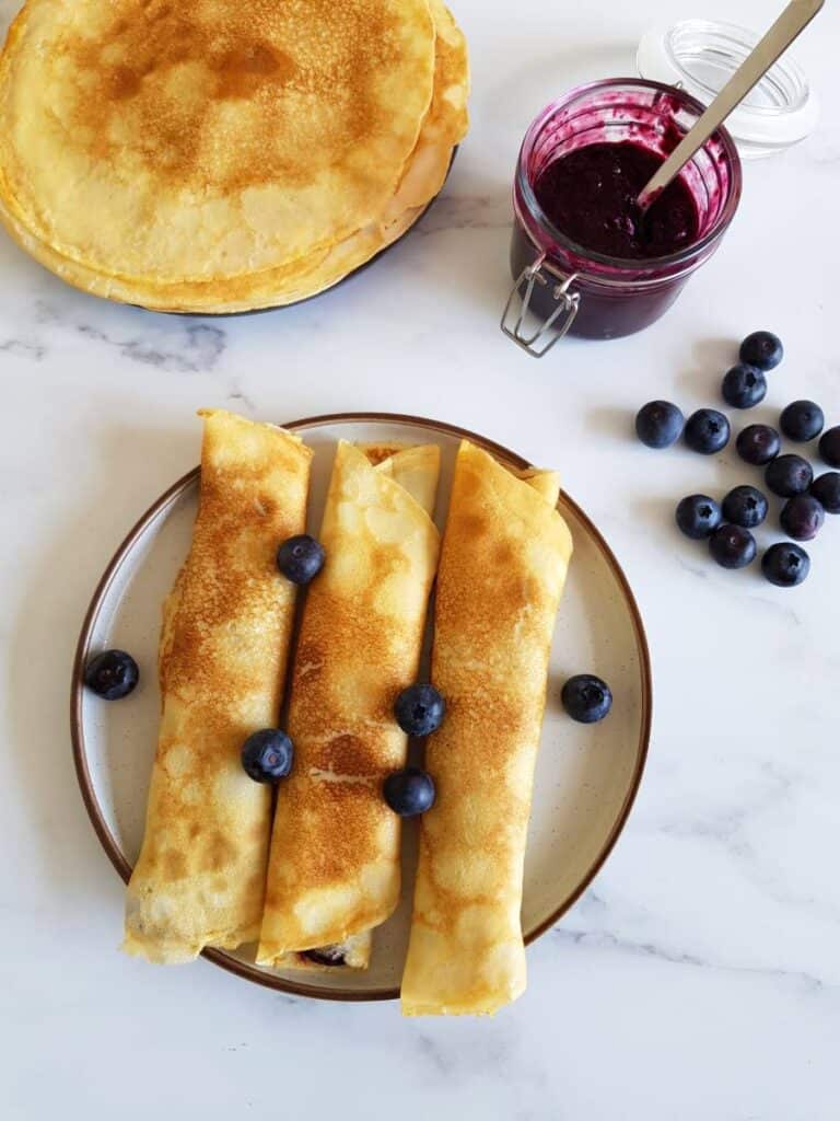 Breakfast crepes with blueberries and blueberry jam 