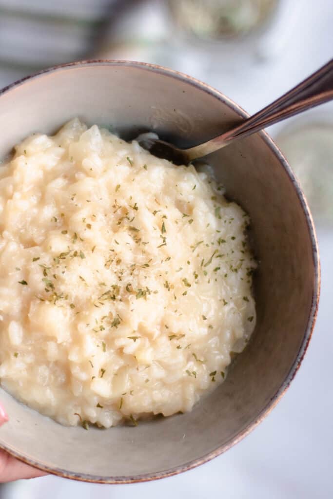 Up Close bowl of parmesan risotto with parsley flakes