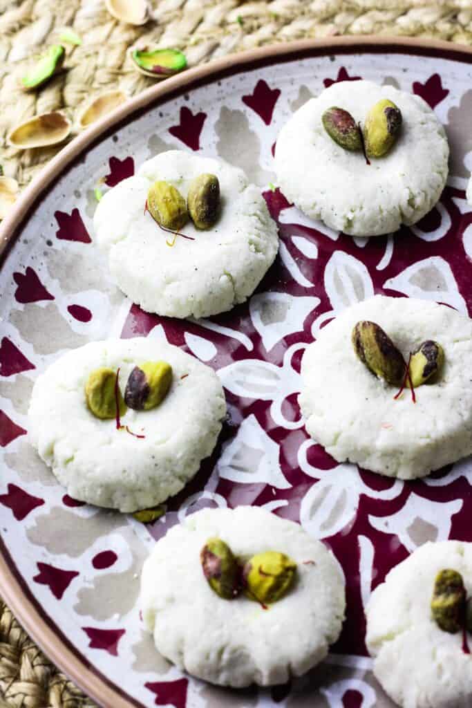 Half plate of shandesh with pistachios on top 