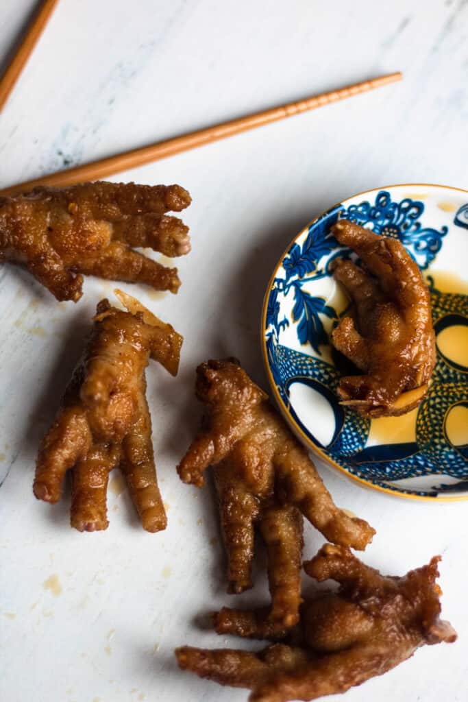 Chicken feet from China with a bowl of sauce
