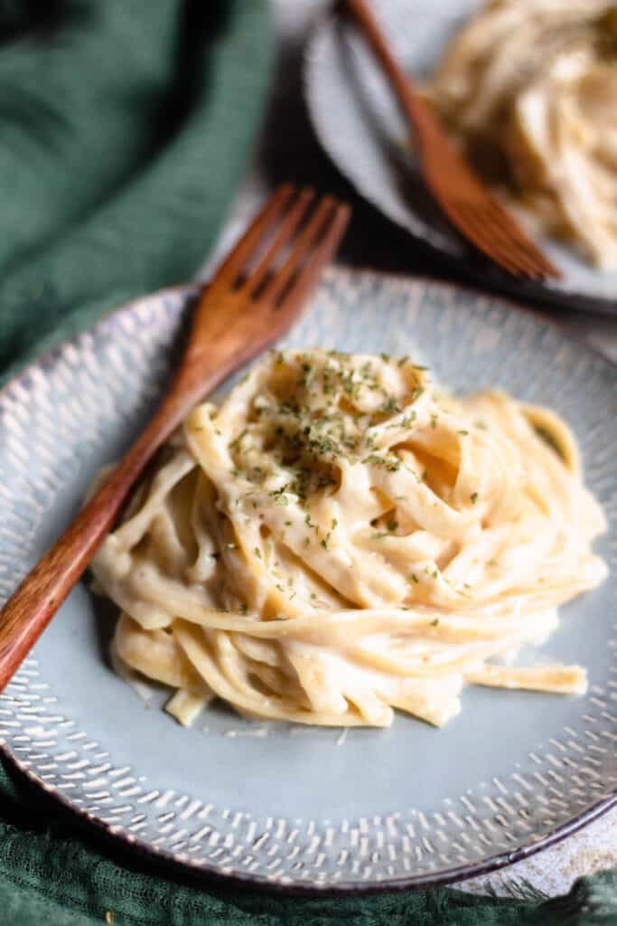 Pile of Fettuccine alfredo with a wooden fork