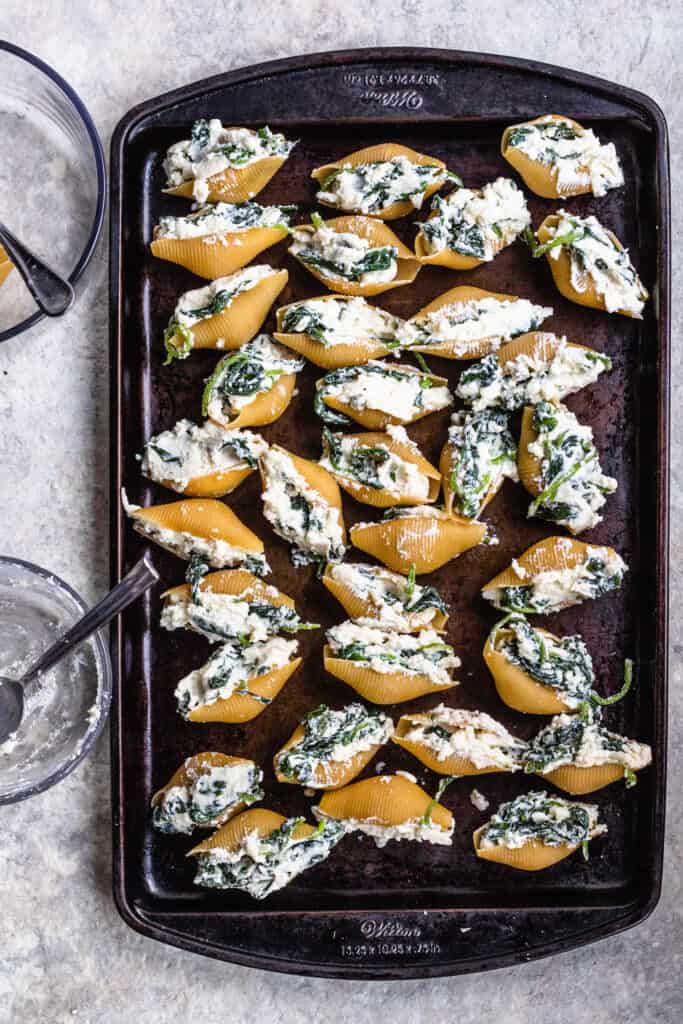 Filled shells on a cookie sheet 