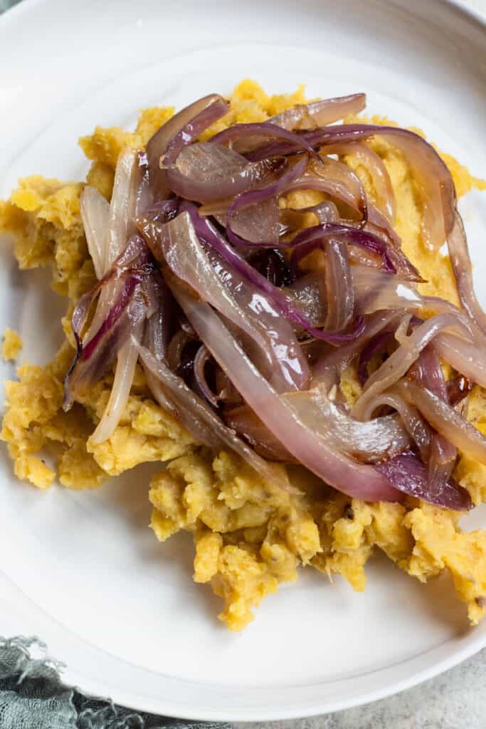 Mangú Dominicana on a plate with sauteed red onions