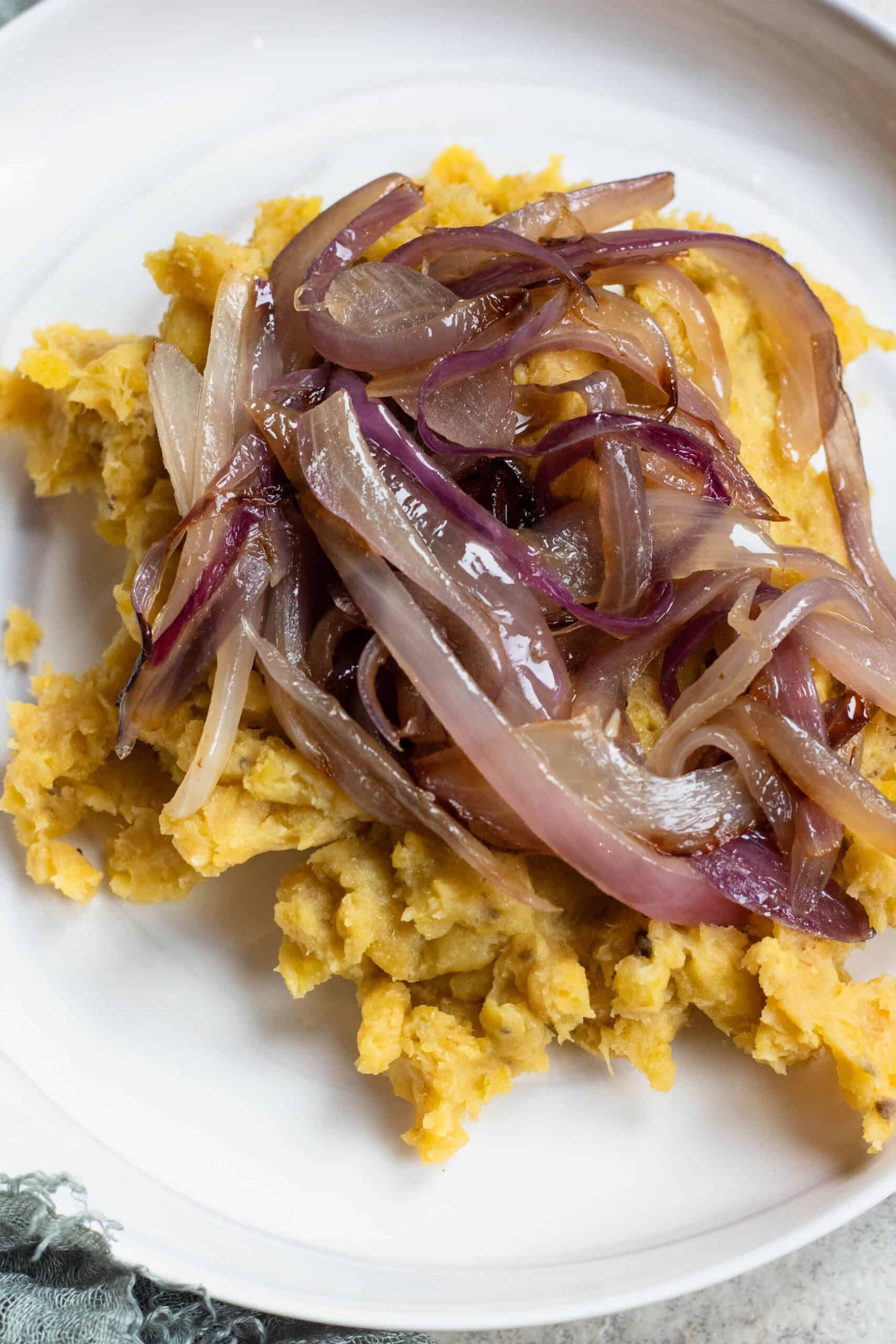 Plate of Dominican Mangu - plantain topped with sauteed onions, a typical Dominican breakfast. 