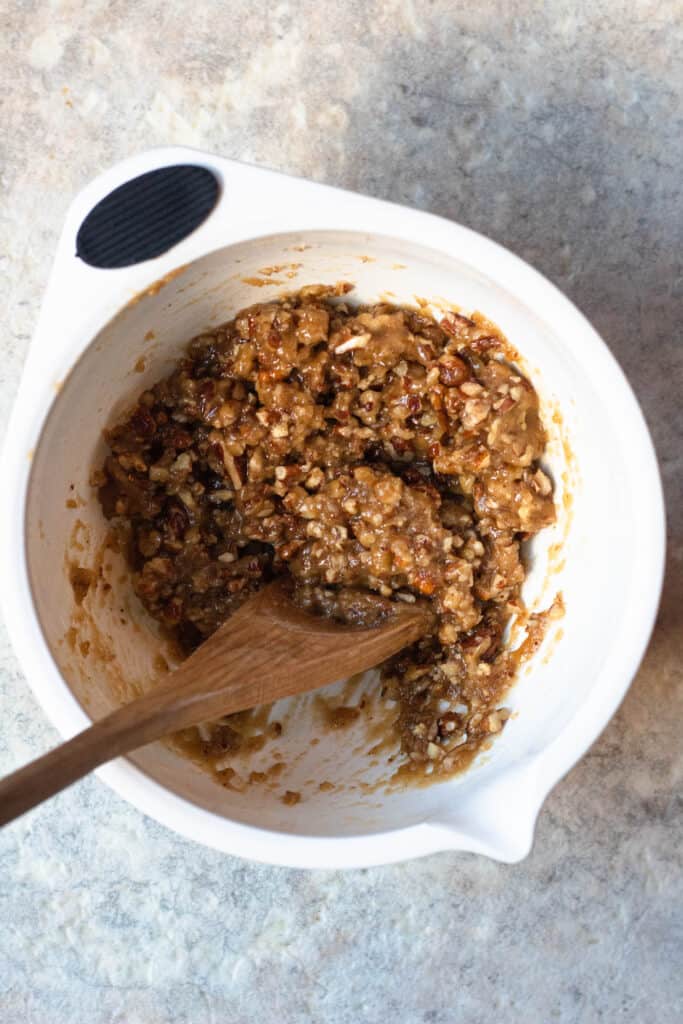 A mixing bowl with brown sugar and pecan topping for sweet potato casserole. 