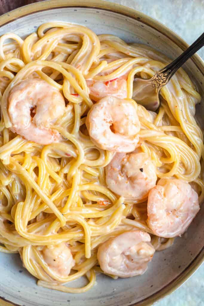 close up of shrimp and pasta with a fork in it