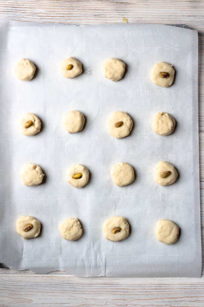 cookie sheet lined with parchment paper and cookie dough 