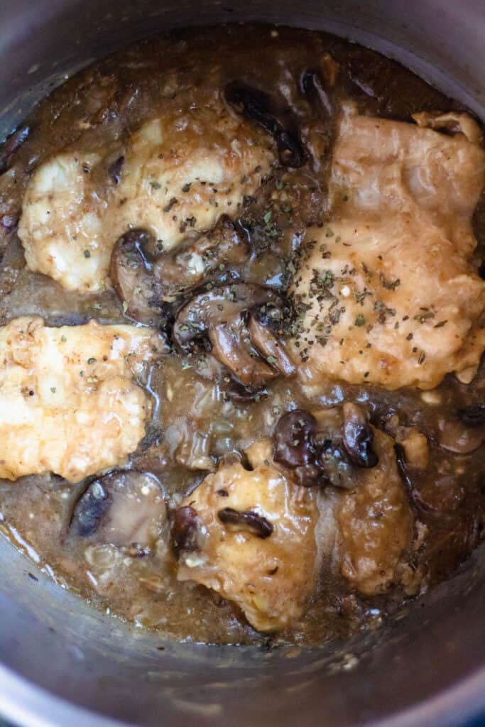 view of the inside of the pot with chicken and mushrooms, making chicken marsala