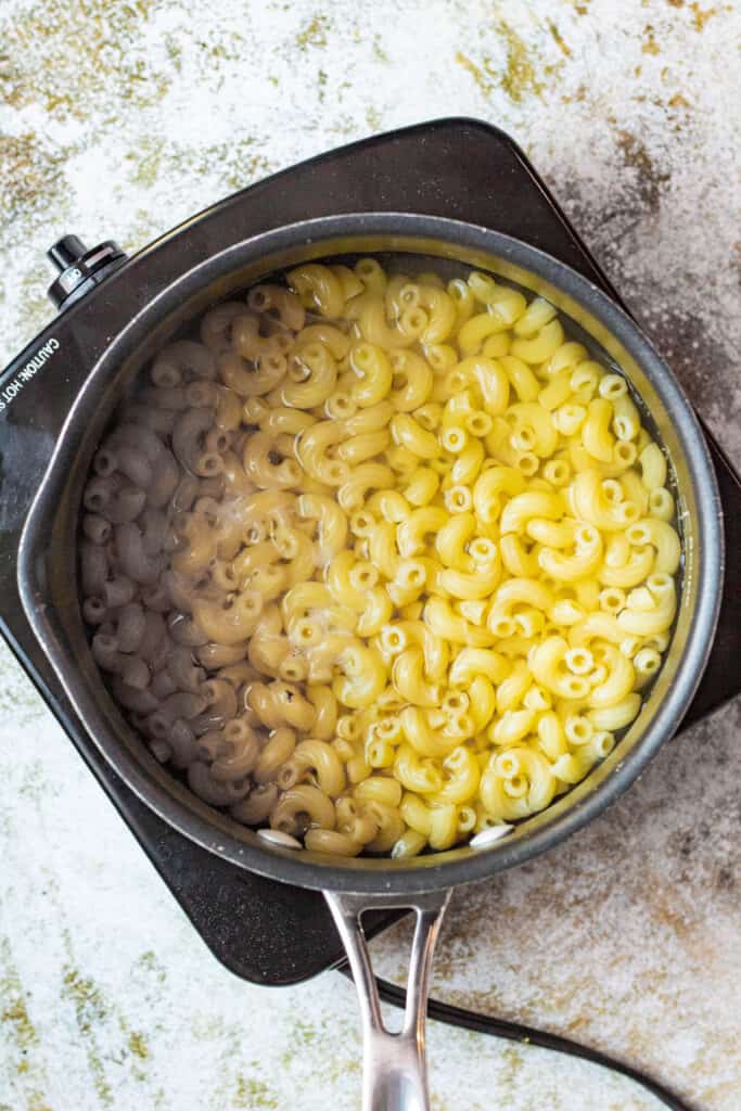 Cooked macaroni noodles in a pot