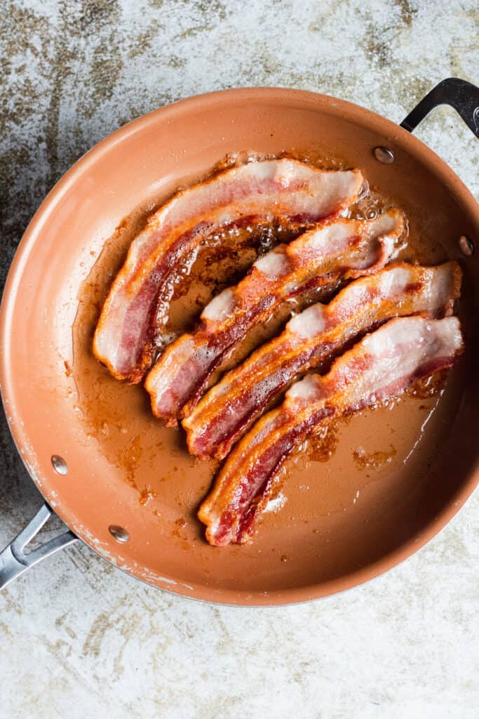 bacon frying in a pan
