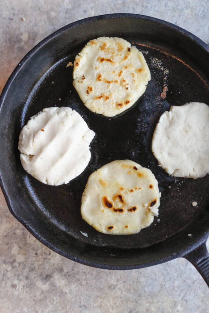 Cooking pupusas in a cast iron skillet