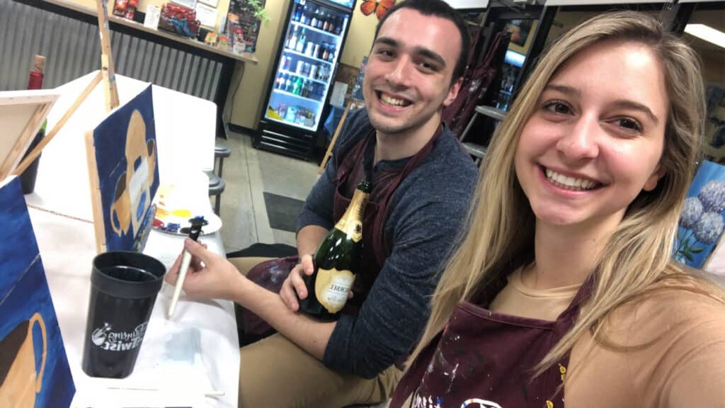 Alexandria and Matt taking a selfie in Painting with a Twist