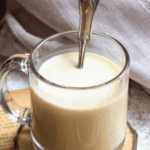 Pinterest image of a cup of Bhutanese Butter Tea with a teaspoon on top of a coaster.