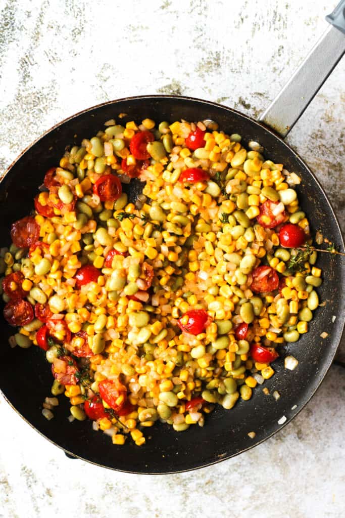 Frying pan full of cooked succotash
