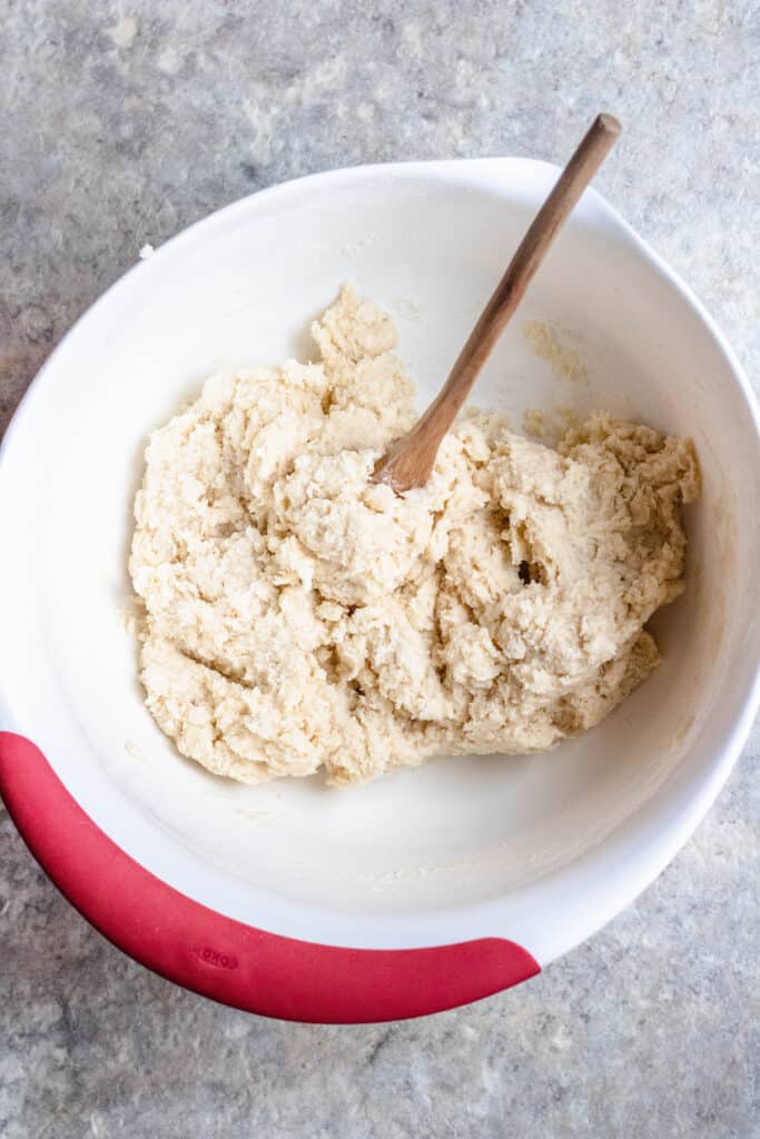 Combined dough with a wooden spoon 