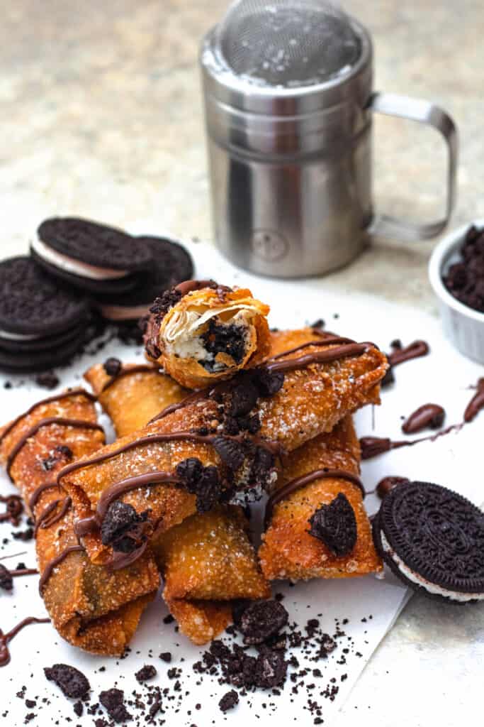 Pile of Oreo egg rolls with powdered sugar Oreo crumbles