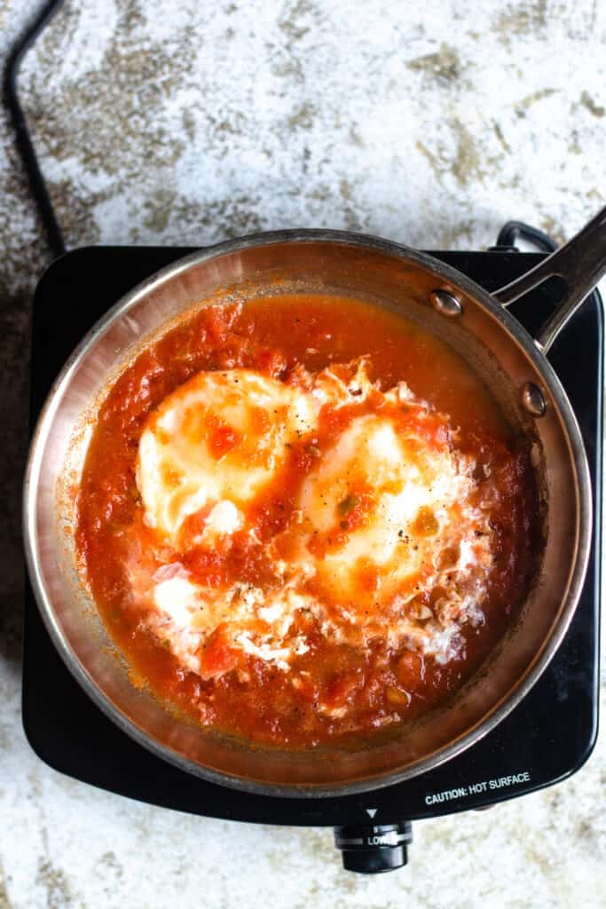 Cooked eggs in salsa
