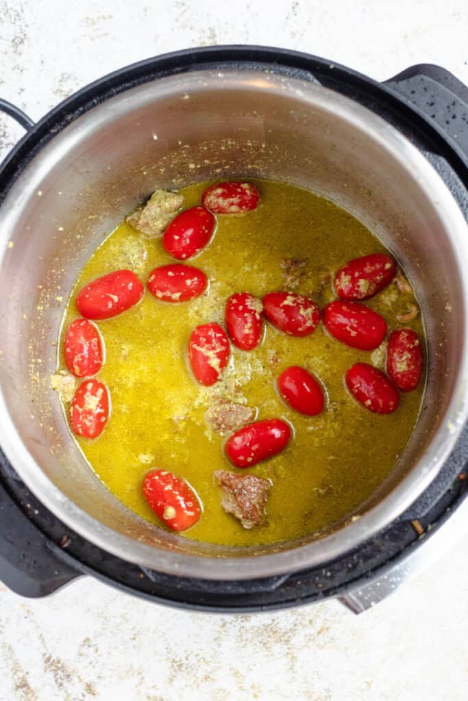 instant pot with pesto and cherry tomatoes 