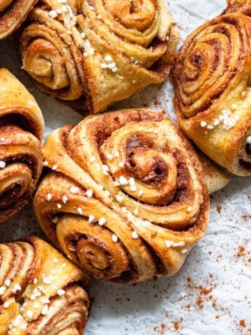 Cinnamon Buns sprinkled with cinnamon powder and topped with Belgian Pearl Sugar.