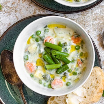 Finnish summer soup topped with green beans with sliced bread spread with butter.