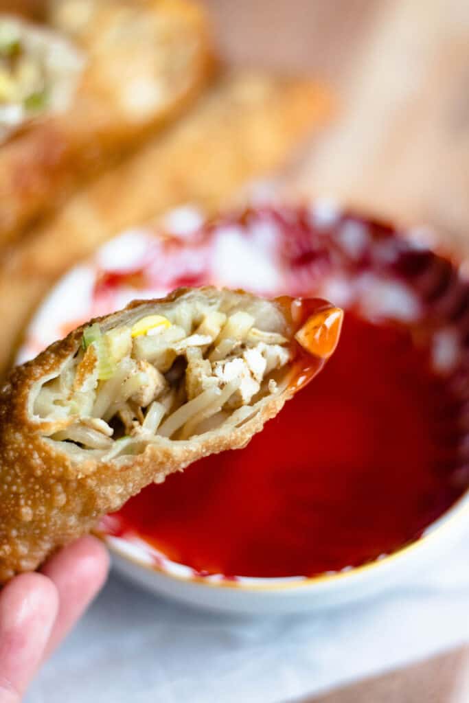 Egg roll dipped in sweet and sour sauce