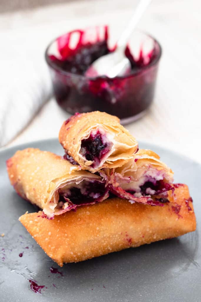 cross section cut of 3 egg rolls with blueberry jam 