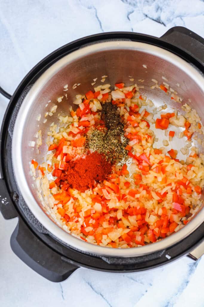 Adding spices to make a sofrito