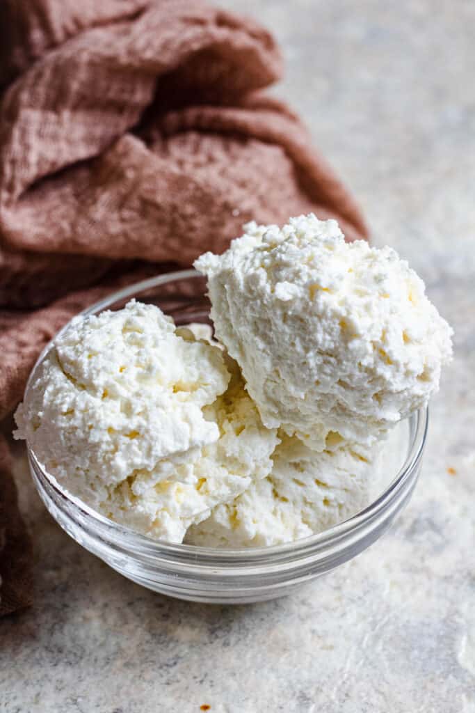 scoops of ricotta cheese with a linen in the background 