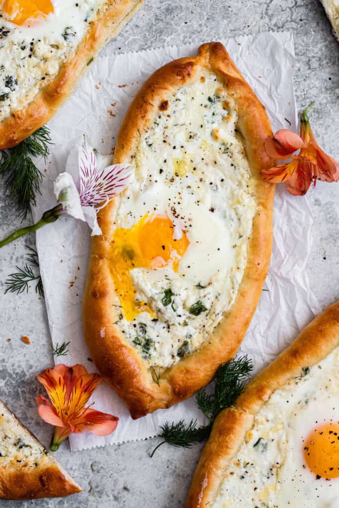 Full Khachapuri with flowers and a runny egg