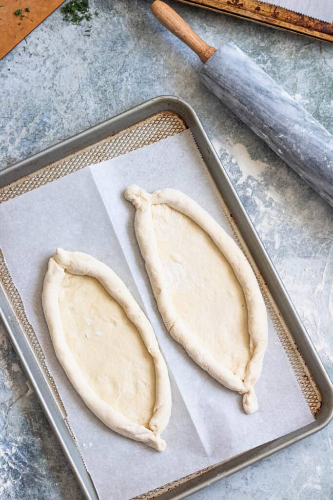 khachapuri bread dough on a cookie sheet