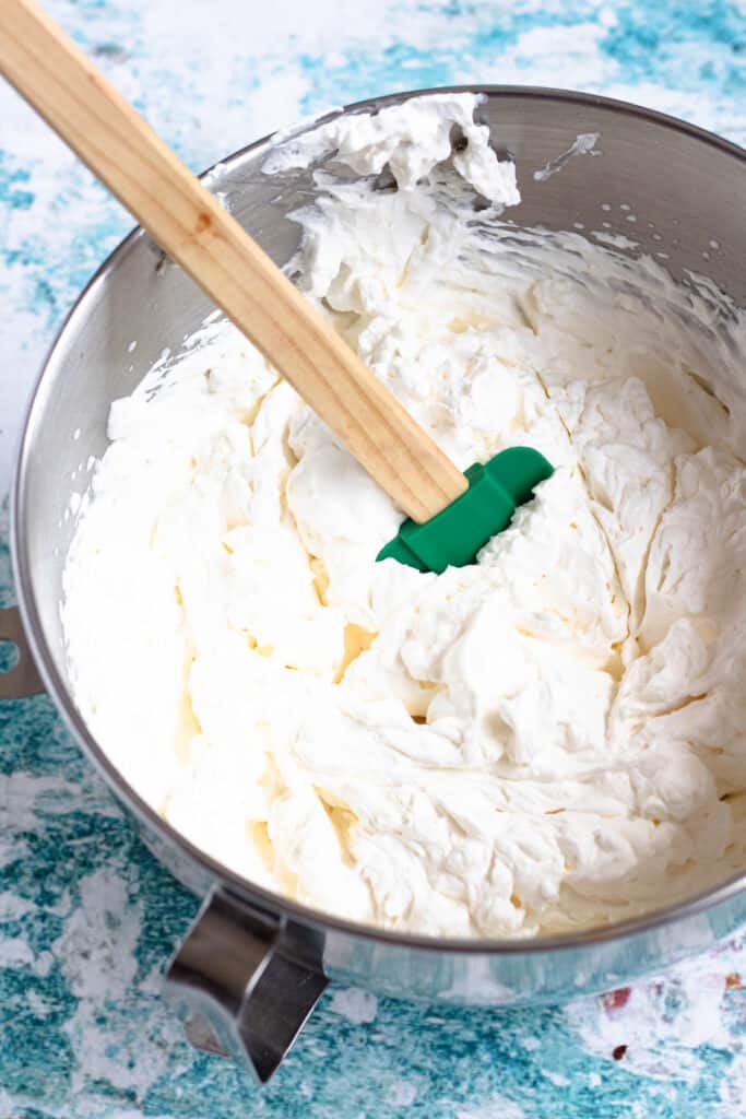 Whipped cream topping in bowl of stand mixer