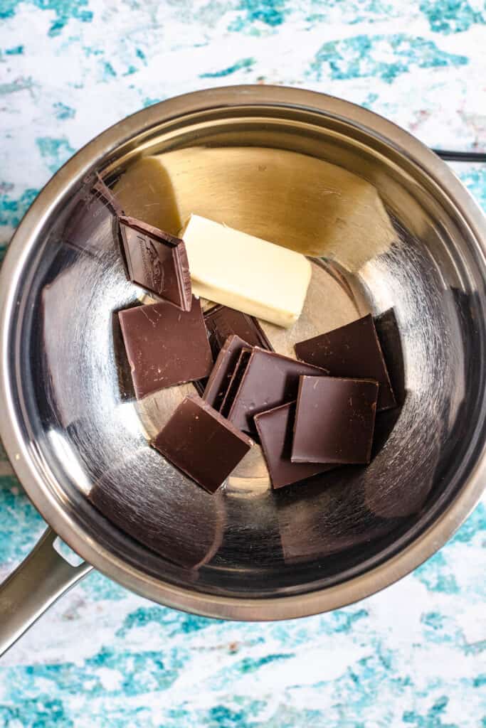 Double boiler with chocolate and butter in a bowl 